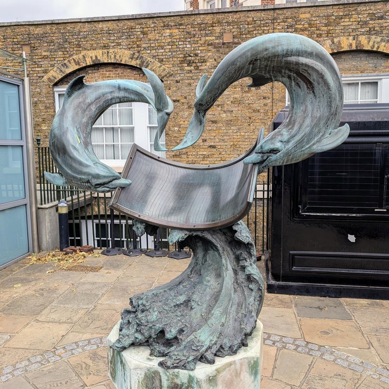 Unusual sundial: the shadows of the two dolphin tails function as gnomons