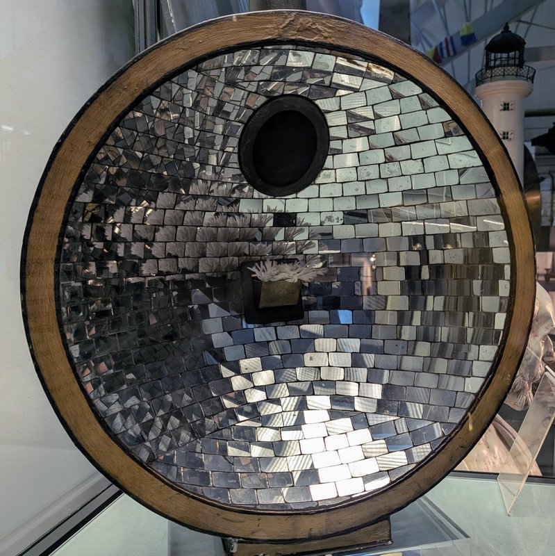 A parabolic mirror, what they used before Fresnel lenses