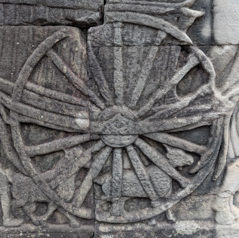 Detail of the cart wheel with goat in background