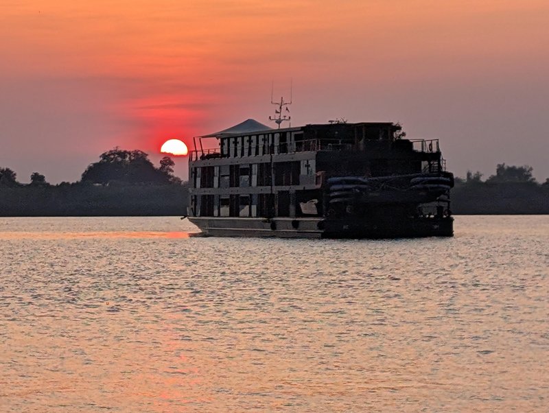 sunset behind cruise ship