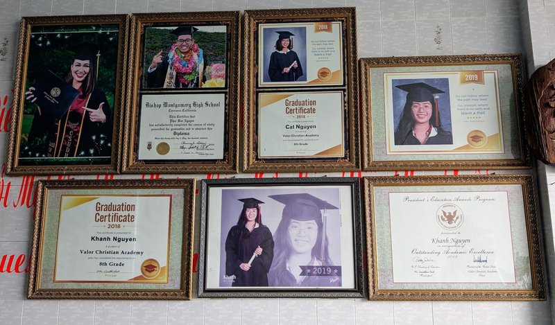 Framed diplomas and photos of various successful kids