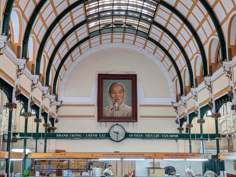 Portrait of Ho Chi Minh smiling over Eiffel's post office lobby